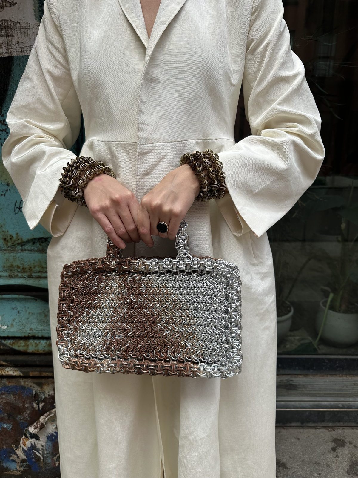 Charlotte Von Hardenburg at the Met Gala Press Preview for the Garden of Time exhibition, carrying a custom rust-colored hand-woven Free Maison chainmail bag in anodized aluminum.